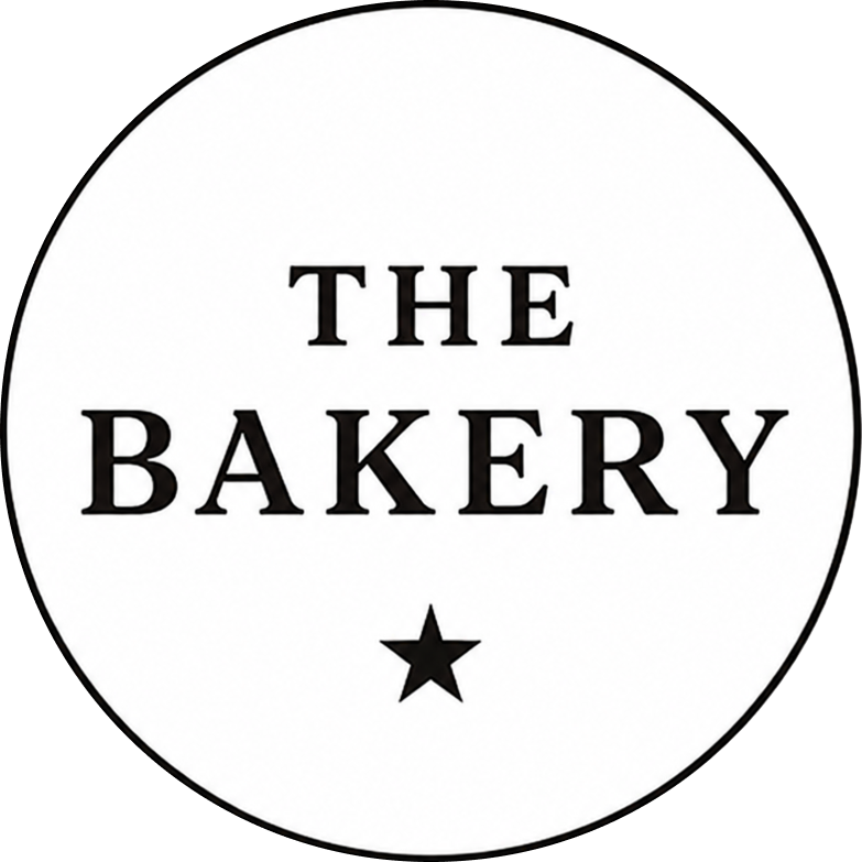 Circular logo for 'The Bakery' with black text and a star on a white background