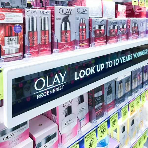 Shelf display of Olay Regenerist skincare products with a banner that reads 'Look up to 10 years younger' in a retail aisle.